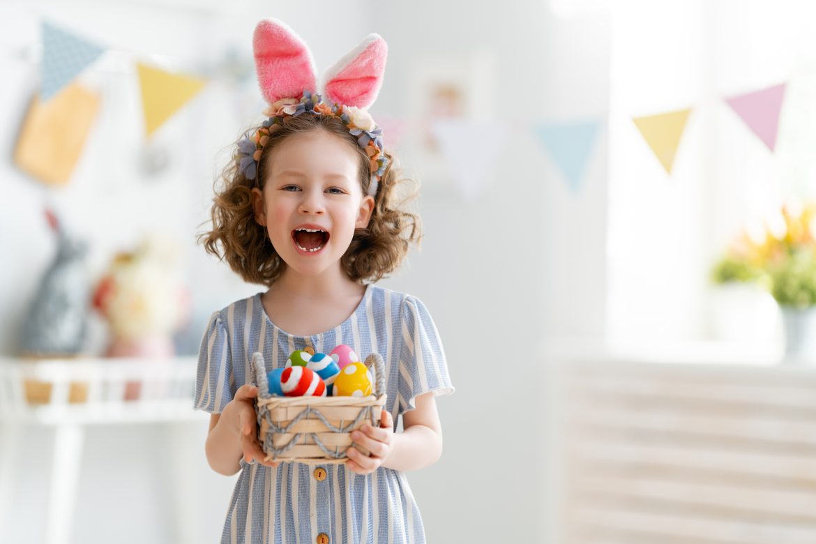 easter activities for kids - girl holding basket with eggs