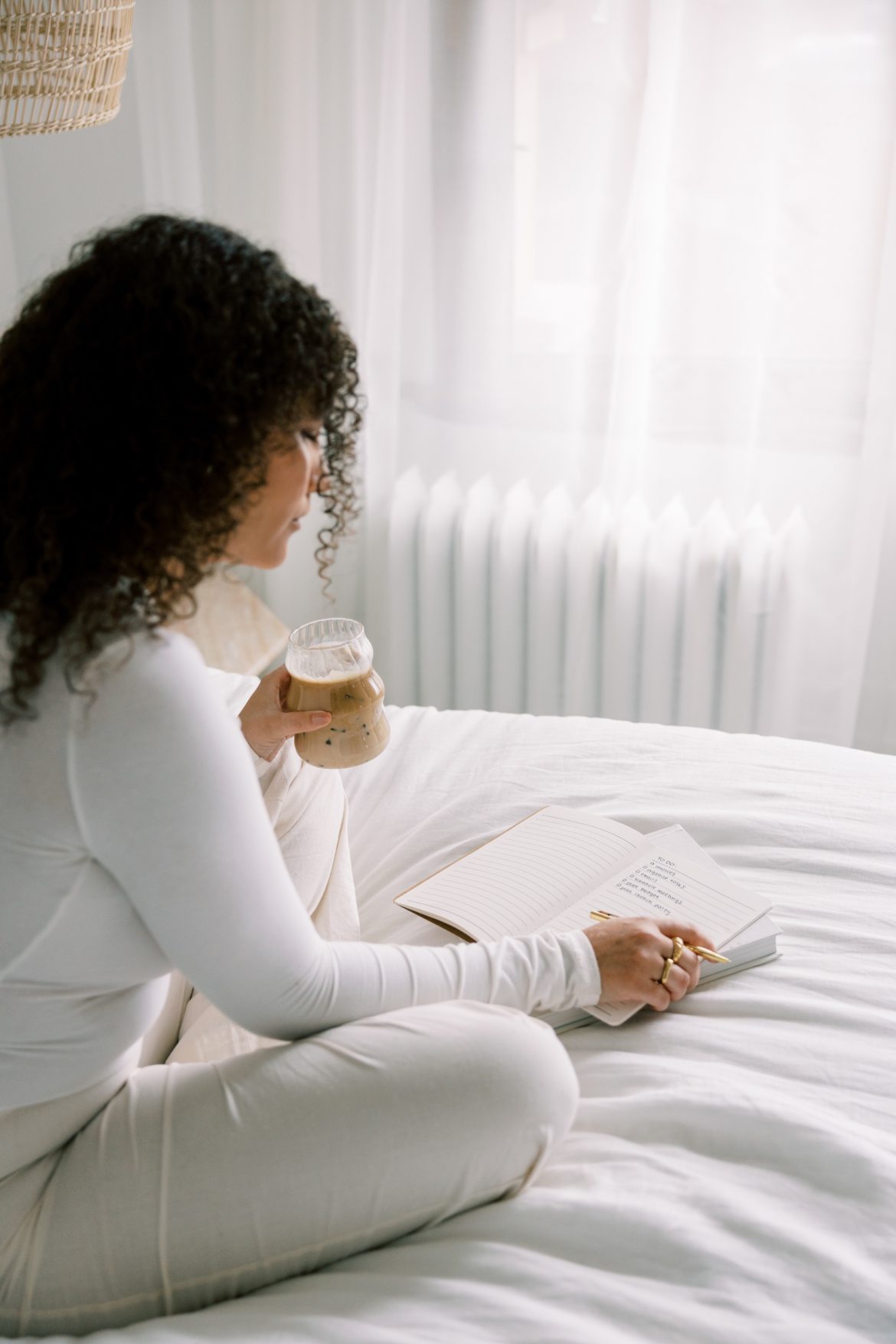 woman sitting on couch with coffee and notebook_how to mentally prepare for iff